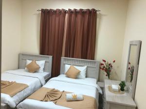 Al Khaleej Plaza Furnished Apartments LLC客房内的一张或多张床位