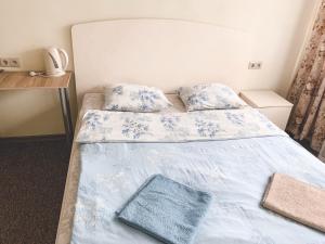 奥金佐沃Complex Uspenka的一间卧室配有两张带蓝白色床单的床