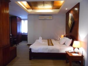 Ban Chéng查姆因劳酒店的酒店客房配有一张床、一张桌子和一部电话
