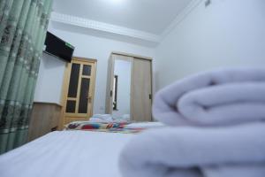 布哈拉Anis-Pari Hotel的一间卧室设有一张床、一个窗口和一面镜子