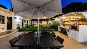 科苏梅尔Vacation Rental - Standard Room at Casa Cocoa的一个带桌子和遮阳伞的庭院