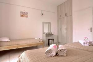 阿里拉斯Makris Apartments Arillas Corfu的一间卧室配有两张带毛巾的床