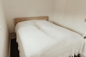 奥利希Apartment Strandnüst的一张位于客房角落的白色床
