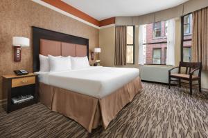 纽约The Hotel at Fifth Avenue的酒店客房带一张大床和一把椅子