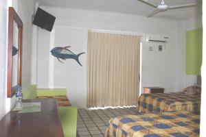 Hotel Arrecife Huatulco Plus客房内的一张或多张床位