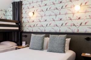 尚特洛普恩布里Best Western Hôtel Grand Parc Marne La Vallée的一间卧室配有一张床,墙上有粉红色鸟