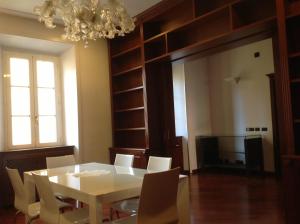 罗马露多维希豪华客房酒店的一间设有白色桌子和白色椅子的用餐室