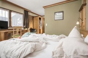 迈尔霍芬Hotel Sieghard Zillertal的一间卧室配有一张带白色床单的大床