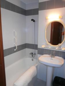 纳瓦莱诺Hostal La Tablada的一间带水槽、浴缸和镜子的浴室