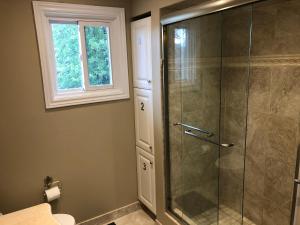 米西索加Comfort Rooms near Toronto Airport的带淋浴的浴室和玻璃门