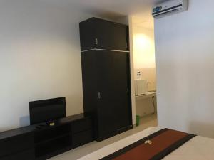 金巴兰赛璐科民宿的客厅配有黑色橱柜和电视