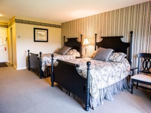 曼切斯特曼切斯特维尤酒店的一间卧室配有两张床和椅子
