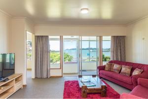 派西亚Te Ra Waitangi的客厅配有红色沙发和电视