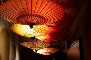 金泽SHIKI Seasonal Colors Kanazawa的悬挂在天花板上的一组五颜六色的伞
