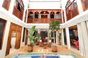 马拉喀什Riad Belle Epoque的一座带游泳池的室内庭院,位于一座建筑中
