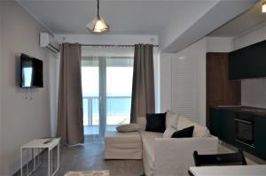 马马亚Mamaia Beach LuxyMar 1 Apartment的客厅配有白色沙发和大窗户