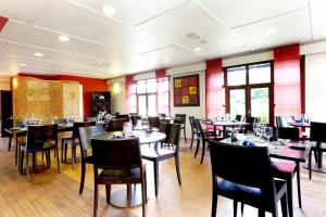 莱蓬德塞南昂热那桥基里亚德酒店的用餐室设有桌椅和窗户。