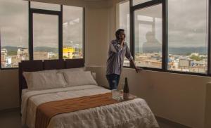 埃斯梅拉达斯Olan´s Hotel Group的一个人在卧室里用手机说话