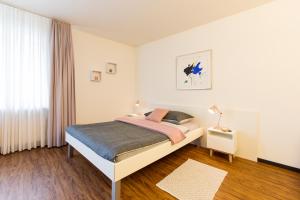巴塞尔Apartmenthaus zum Trillen Basel City Center的白色的卧室设有床和窗户
