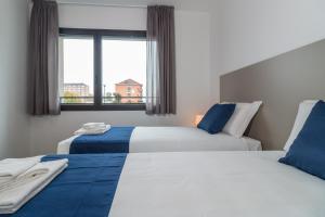 Hotel Cascina Fossata & Residence客房内的一张或多张床位