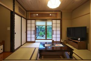 金泽Musashi Sakaean的客厅配有电视和茶几