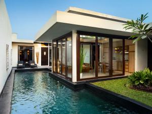 塞米亚克Avani Seminyak Bali Resort的一座房子前面设有游泳池