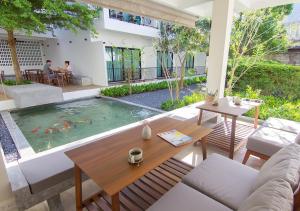 奥南海滩Mini House Aonang Hotel SHA Plus的客厅设有桌子和游泳池