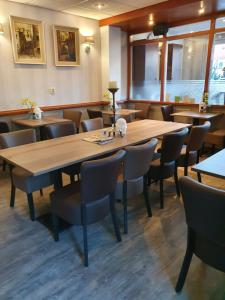 梅珀尔梅珀尔城市酒店的餐厅设有一张大型木桌和椅子