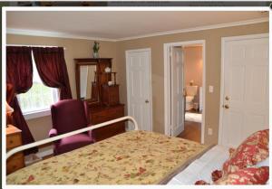 Cornwall Bridge康沃尔宾馆的卧室配有床、椅子和窗户。