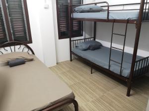 怡保Homey Hostel的带两张双层床和长凳的房间