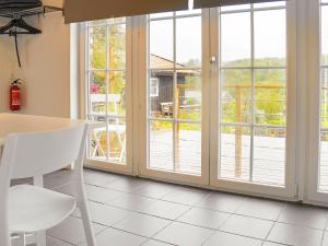 谢尔港4 person holiday home in Sk rhamn的厨房设有滑动玻璃门、桌子和椅子