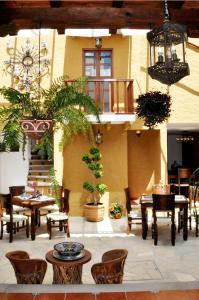 圣克里斯托瓦尔-德拉斯卡萨斯卡萨圣露西亚酒店的一座配有桌椅的庭院和一座建筑