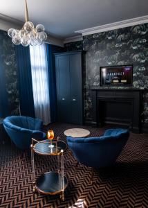 利物浦Lock and Key Boutique Hotel - Duke Street的客厅配有蓝色椅子和壁炉