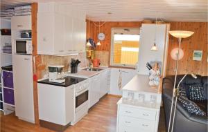 博托比3 Bedroom Gorgeous Home In Vggerlse的小厨房配有白色橱柜和水槽