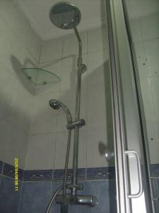 卡萨布兰卡Appartement Aznavour的一个带玻璃门和雨伞的淋浴