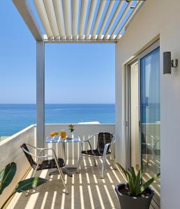 海若克利欧亚特瑞恩酒店的一个带桌椅的海景阳台
