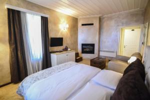 阿拉霍瓦Guesthouse likoria的卧室配有白色的床和电视。