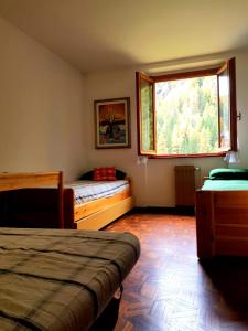 尚波吕克Monterosa Apartment - Champoluc #Bluchalet的一间卧室设有两张床和窗户。