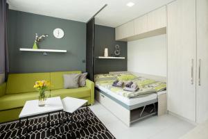 斯托泽克Apartmány Stožec - Stela Premium的一间卧室配有一张床、一张沙发和一张桌子