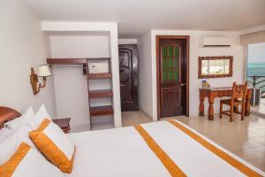 圣安德烈斯加勒比海太阳鲜花酒店 的一间卧室配有一张床、一张桌子和一张桌子