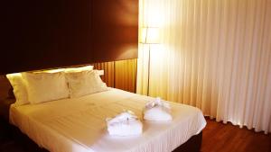 ValdosendeAgrinho Suites & Spa Gerês的酒店客房,配有带毛巾的床