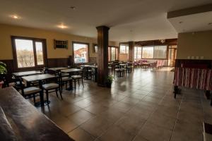 埃尔卡拉法特圣朱利安港旅馆的一间在房间内配有桌椅的餐厅