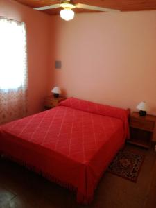 费德拉西翁Casa Marian的一间卧室设有红色的床和窗户。