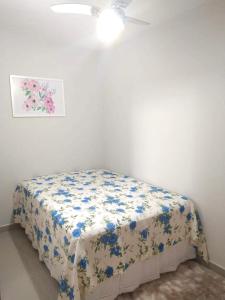 阿拉亚尔-杜卡布Bela casa的一间卧室配有一张带花卉床单的床