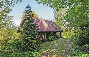 Asperup哈勒温格特度假屋的一座小房子,四周生长着树
