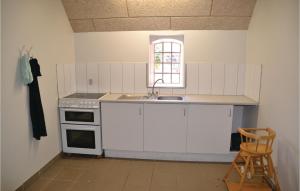 StavsøCozy Apartment In Nrre Nebel With Wifi的厨房配有白色橱柜、水槽和窗户。