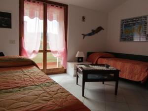 阿祖罗港Albariba的一间卧室配有一张床、一张桌子和一个窗户。