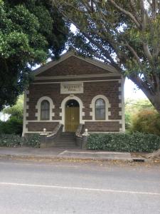 AngastonAngaston Masonic Lodge的黄色门的小砖砌建筑