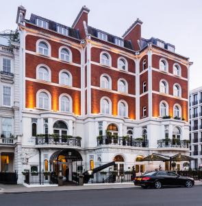 伦敦伦敦巴廖尼酒店-立鼎世酒店集团的前面有停车位的建筑