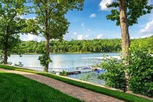 LampeChalets Resort Luxury Lakefront Villa Family Friendly 2 Pools Free Amenities的树木繁茂的湖面上的码头